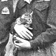 Members of the Polish Carpathian Lancers photographed with a tabby kitten