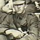 Enlargement from Australian soldiers on troopship, 1916, showing soldier holding a cat - click to enlarge