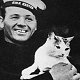 Ship's cat Scouse of HMS Exeter, with Herbert Chalkley